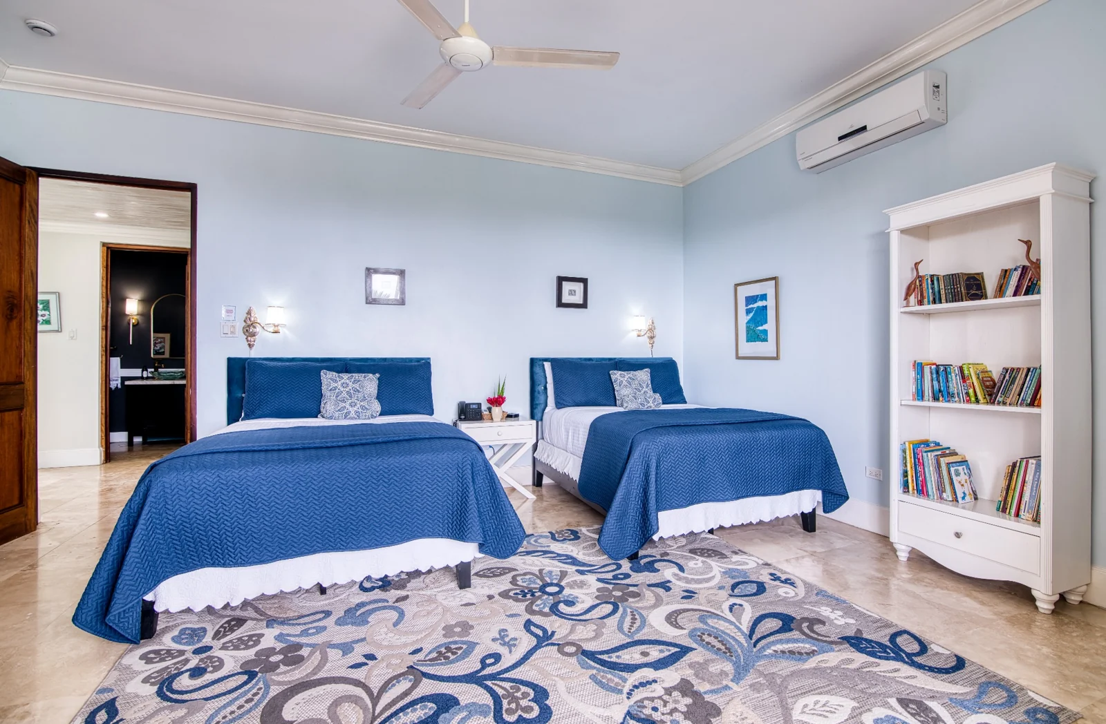 Bedroom with two blue upholstered beds