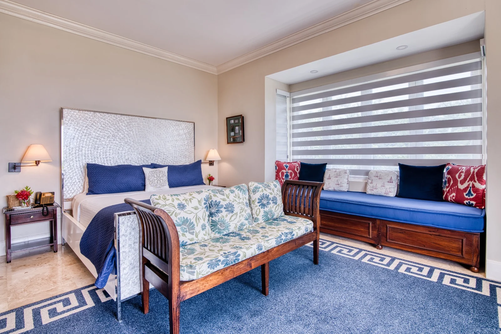 Bedroom with seating and blue accents